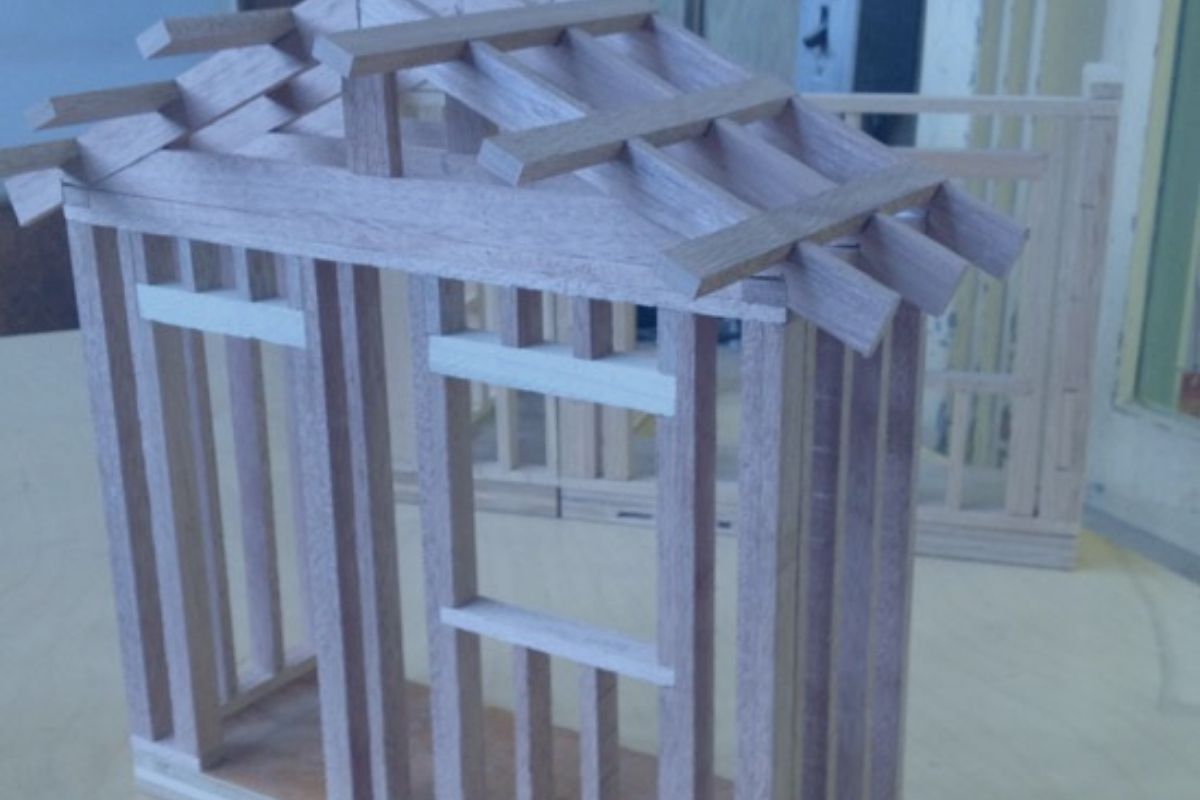 framework for a model of a house using wooden pieces